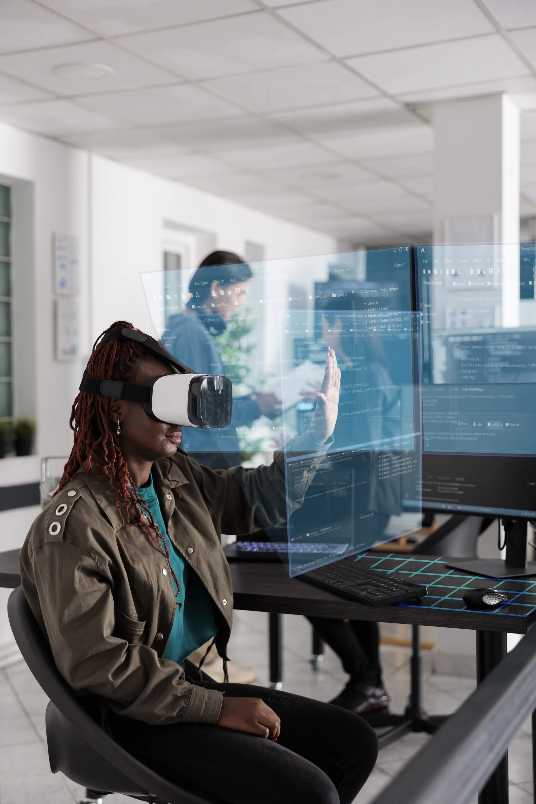 augmented reality vs virtual reality: African American programmer writing code and using holographic program with augmented reality, displaying artificial intelligence algorithm. Web developer coding database and checking ar hologram.